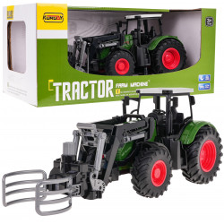 Zelený traktor s drapákom